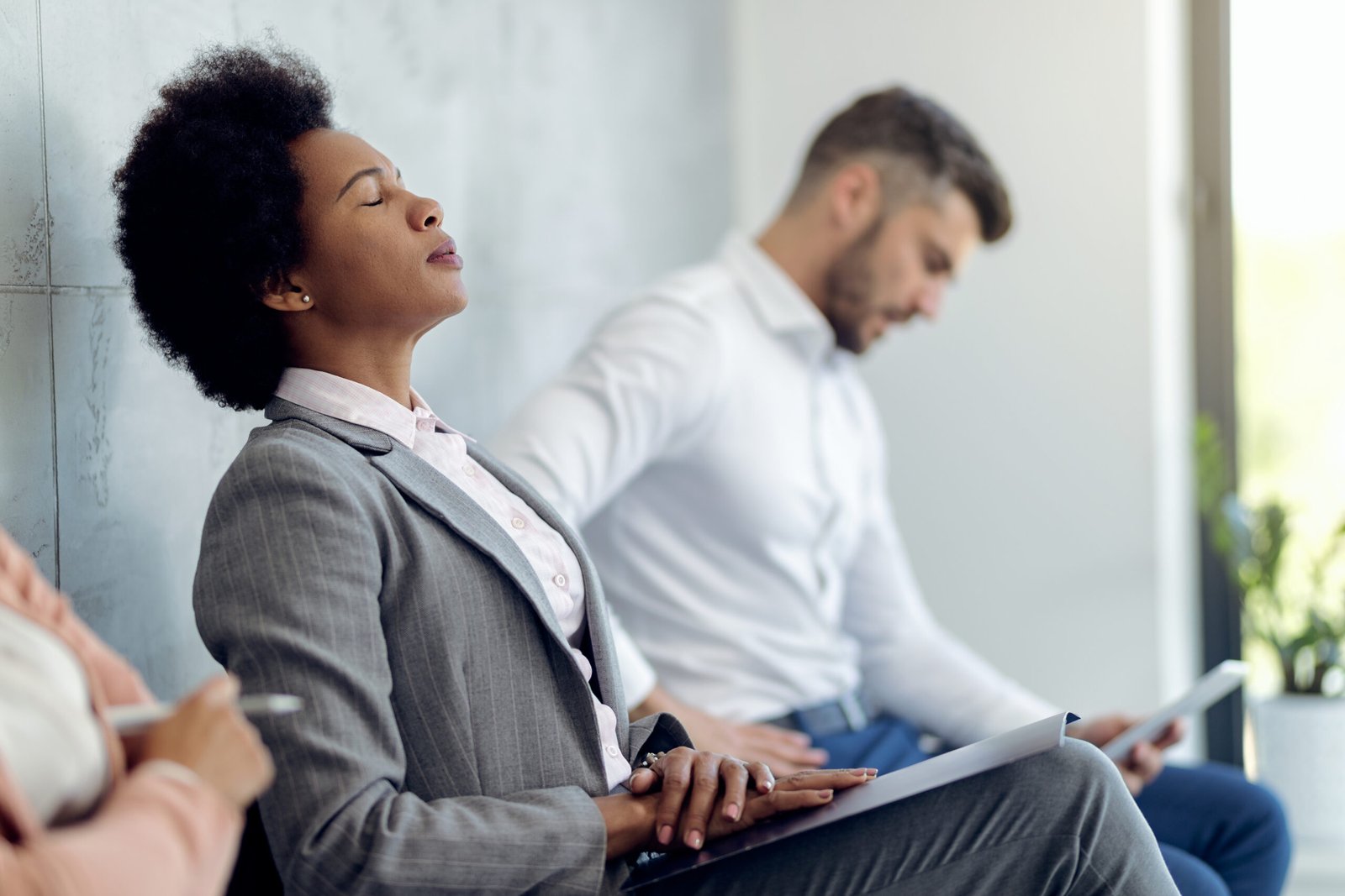 African American businesswoman trying to concentrate while waiting for a job interview.